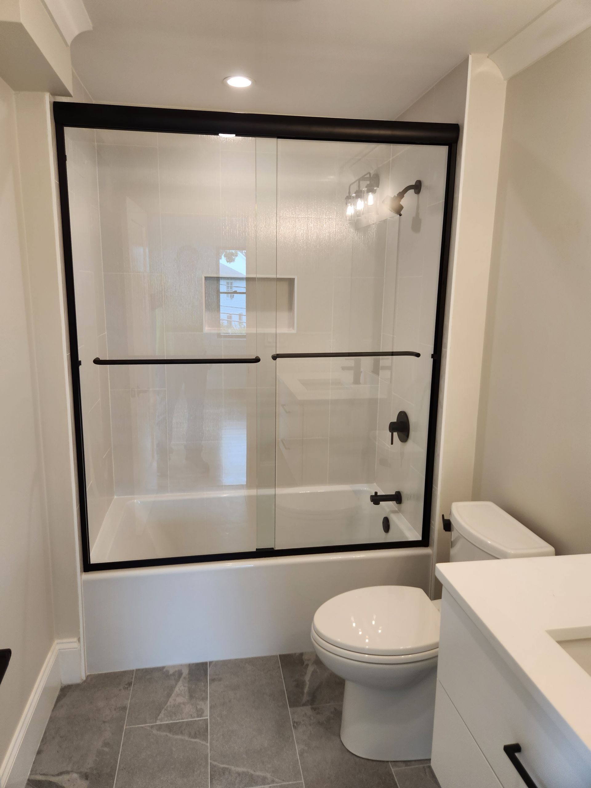 A bathroom with a bathtub toilet and sink