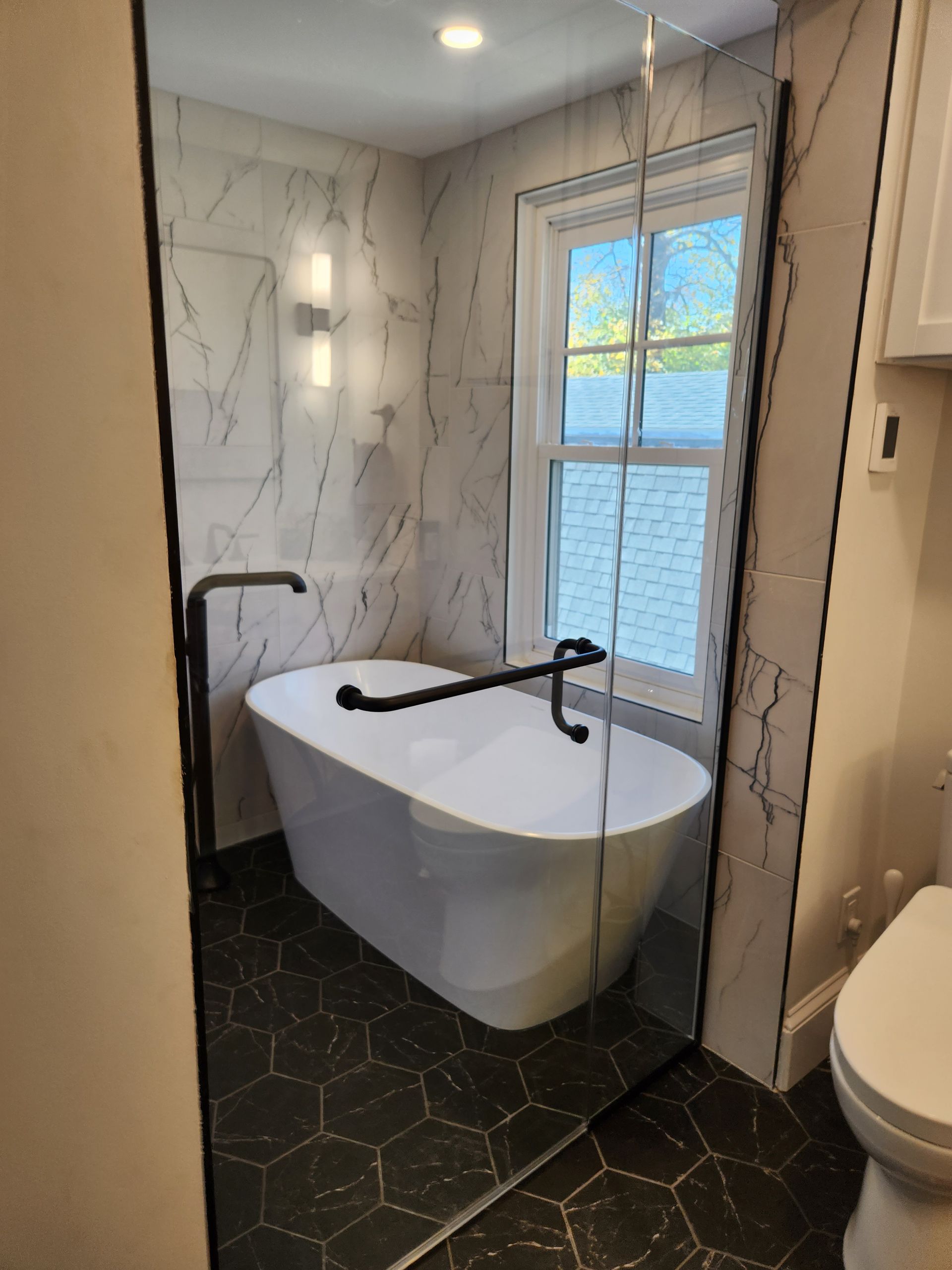 A bathroom with a bathtub and a toilet