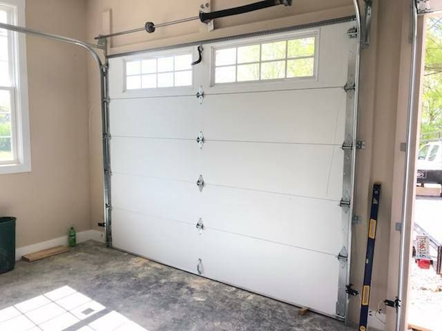 White garage door with windows, inside a garage.