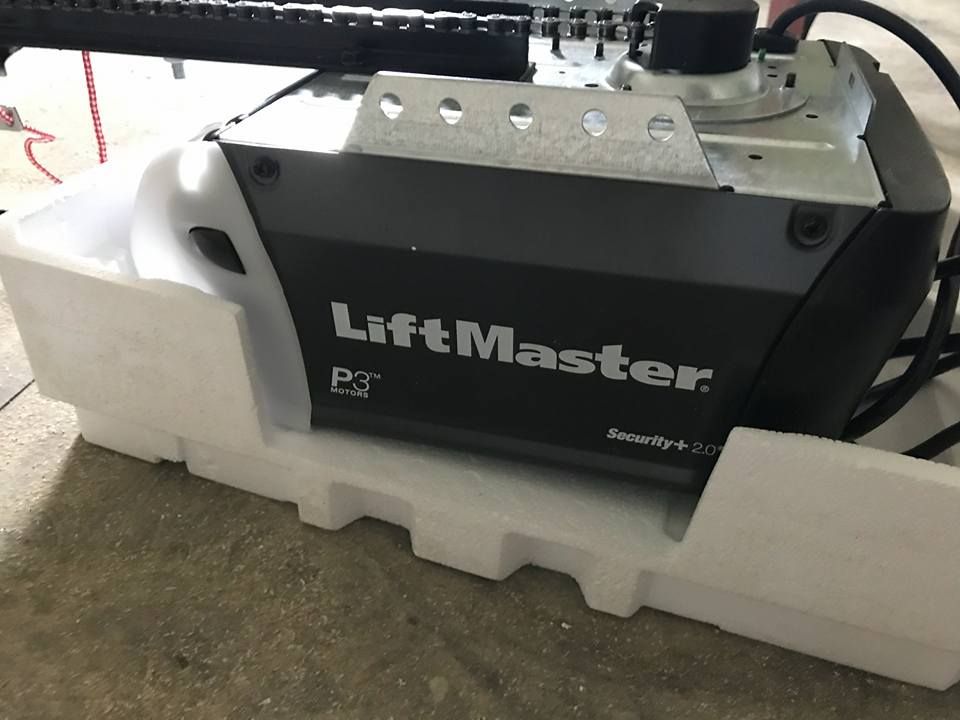 LiftMaster garage door opener on a styrofoam base. Black unit with white lettering, mounted on a chain rail.