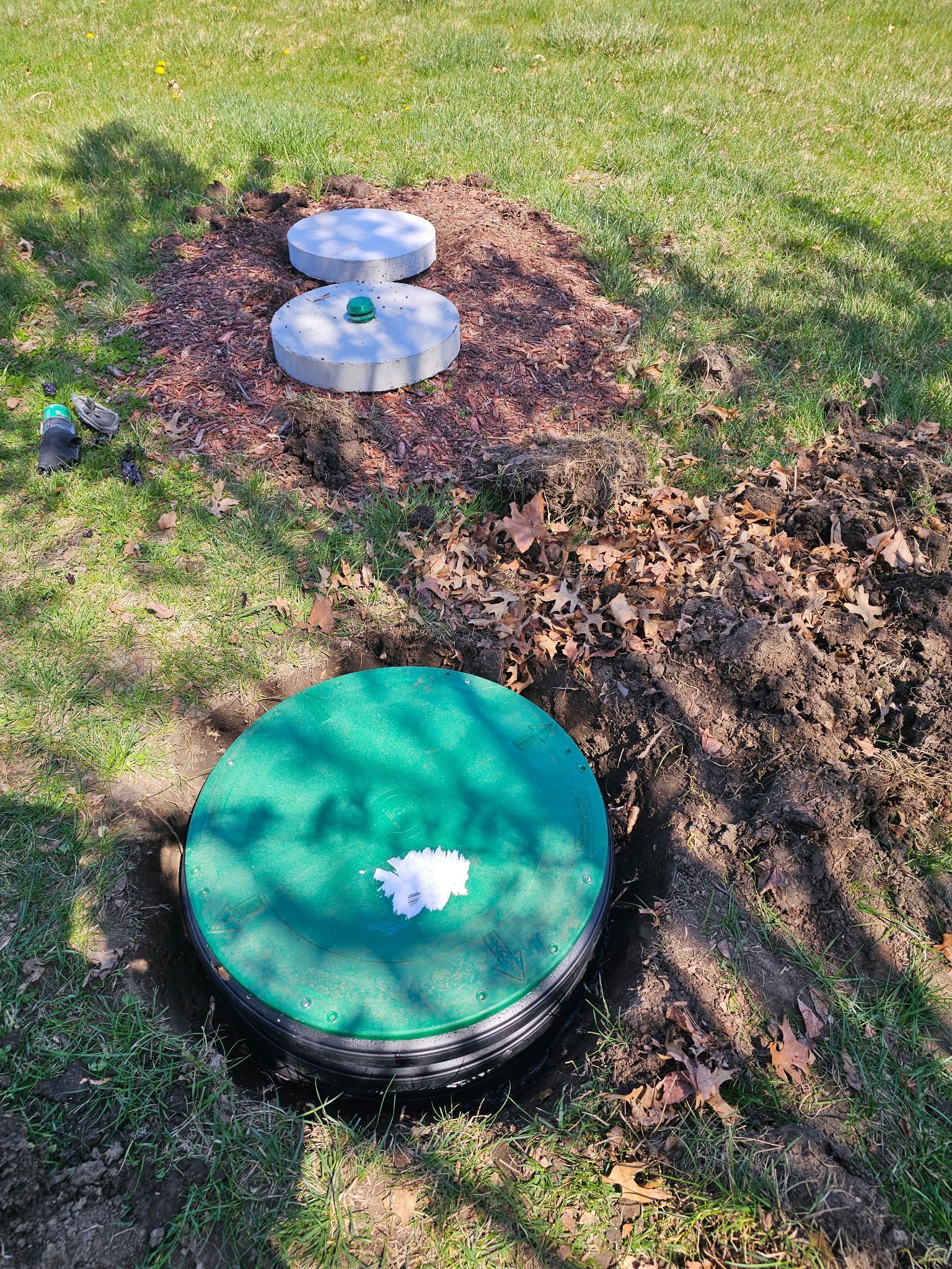 Green metal golf course light post on grass.