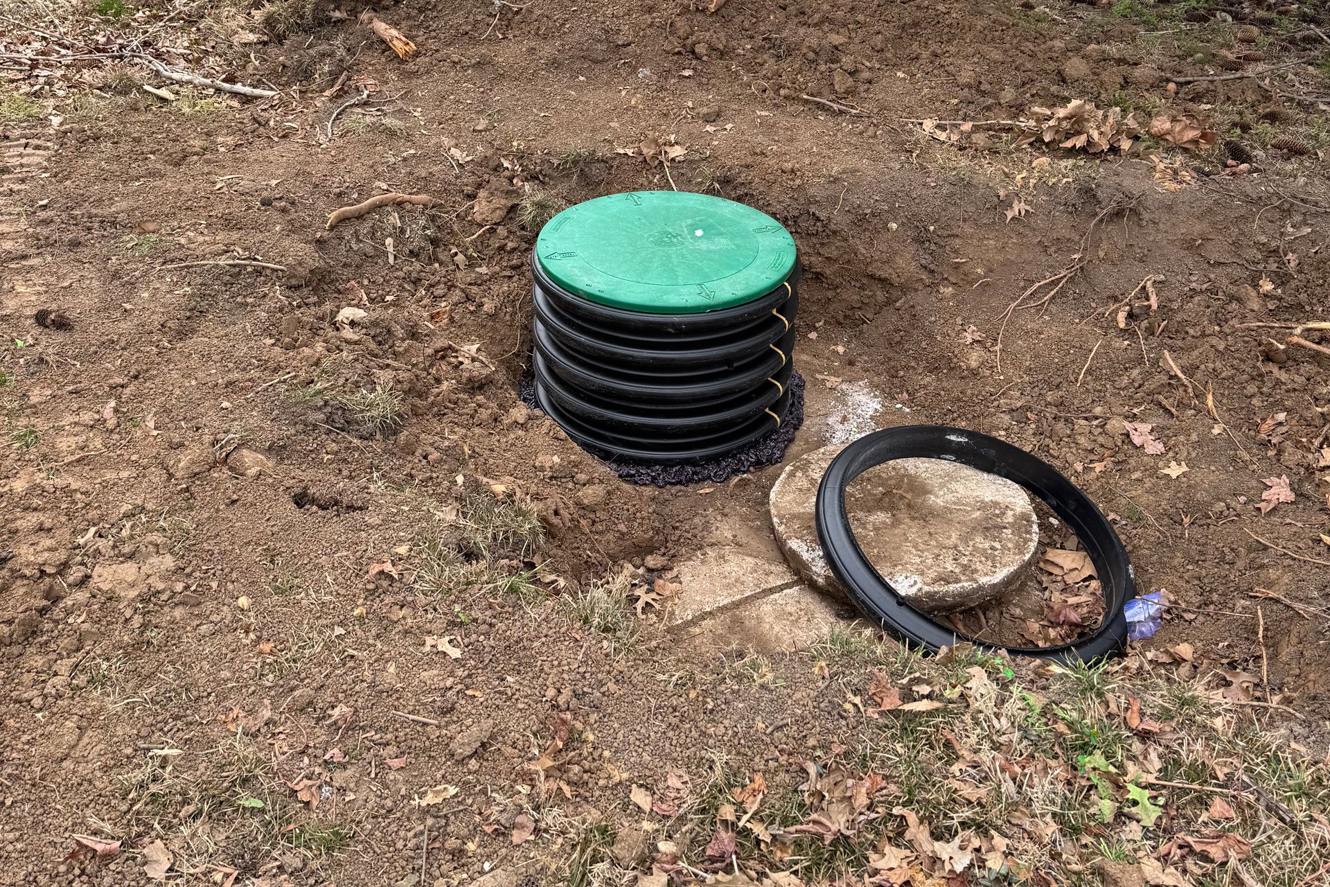 Yellow level and tree stump in dirt patch on grass.