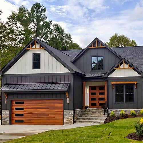 Modern house with gray siding, wooden accents, and a brown garage door.