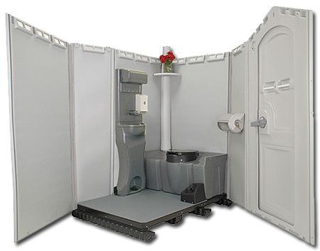 Open-concept portable restroom with toilet, sink, and decorative flowers on a pedestal table. Gray and white plastic construction.