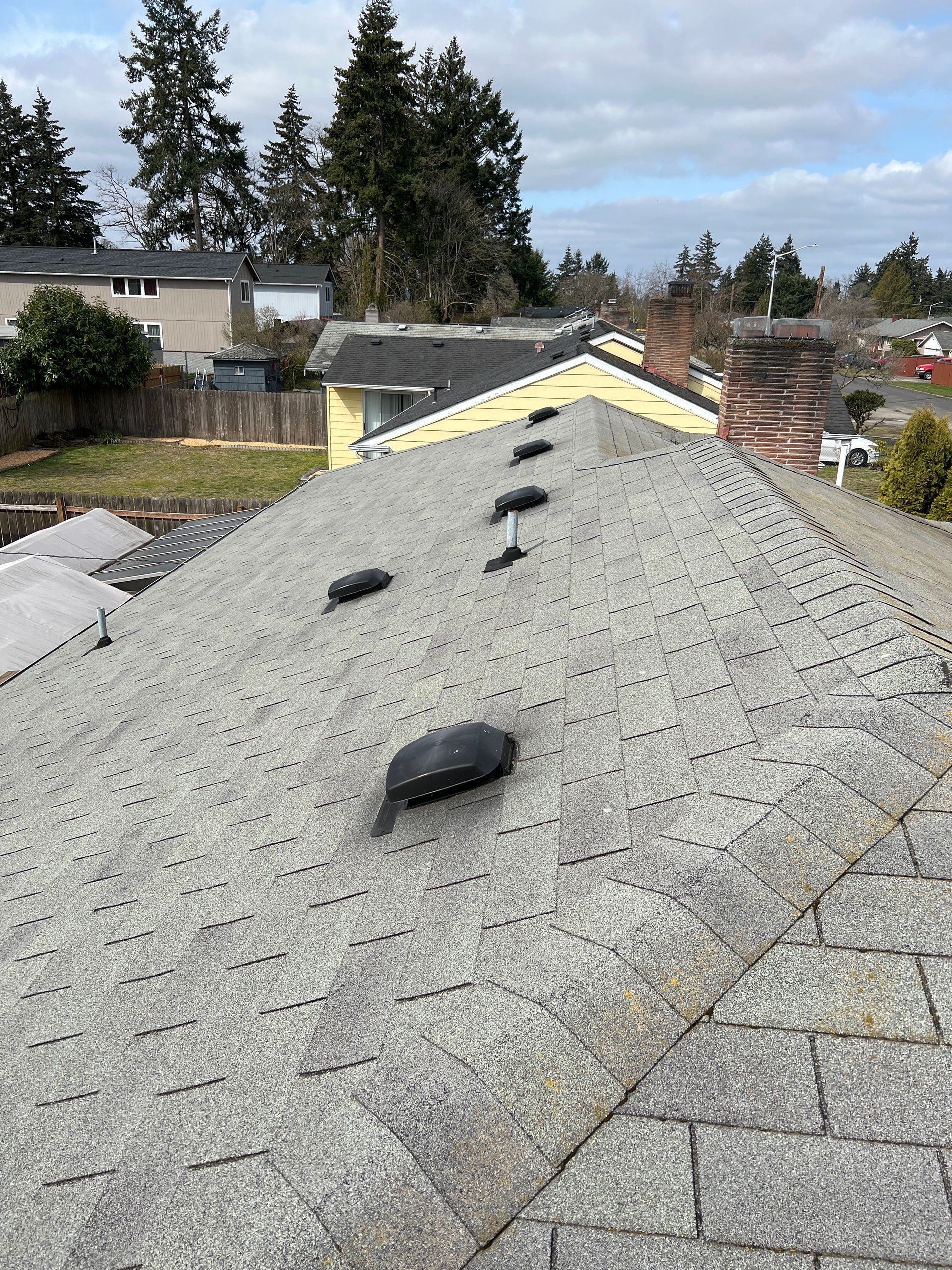 A roof of a house with a chimney on it