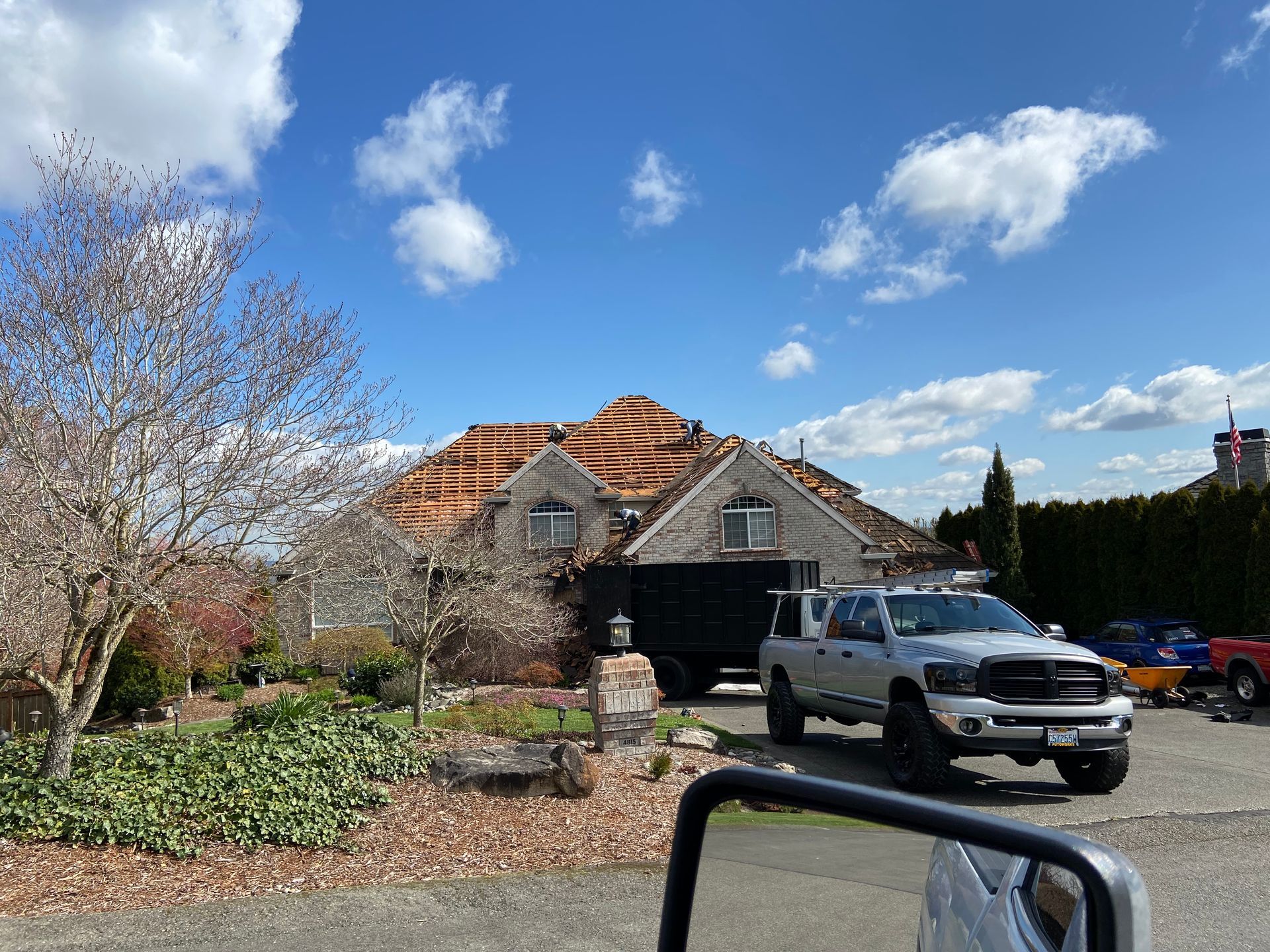 A truck is parked in front of a house under construction.