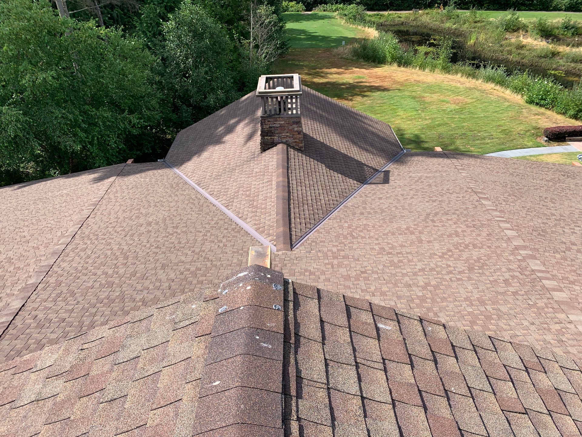 An aerial view of a roof with a chimney on top of it.