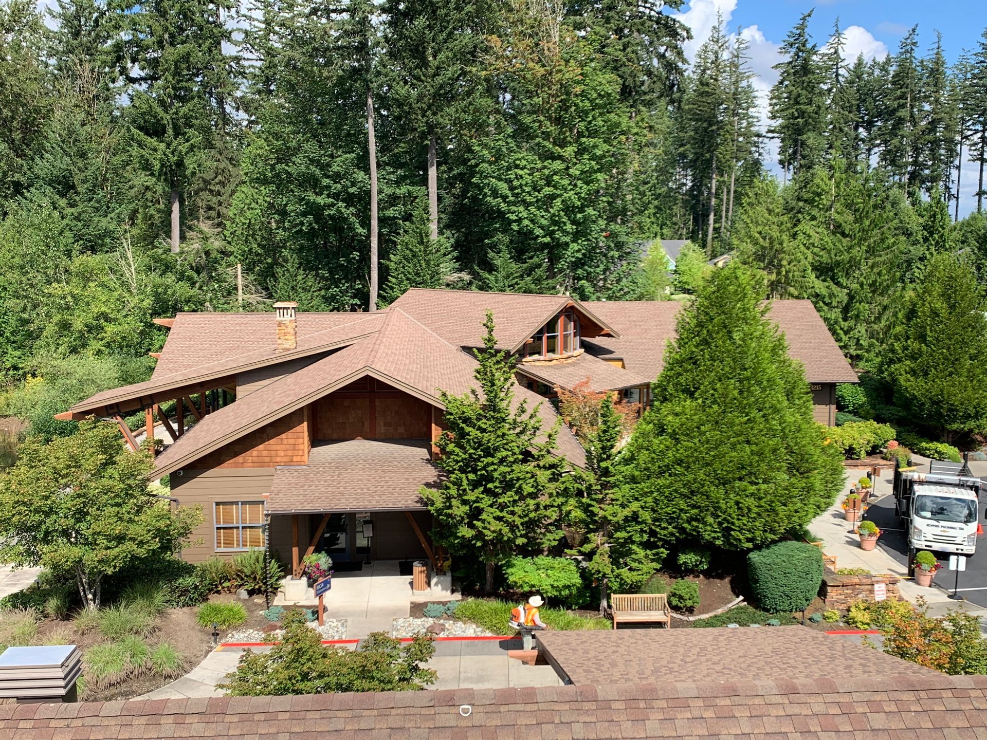An aerial view of a large house surrounded by trees.