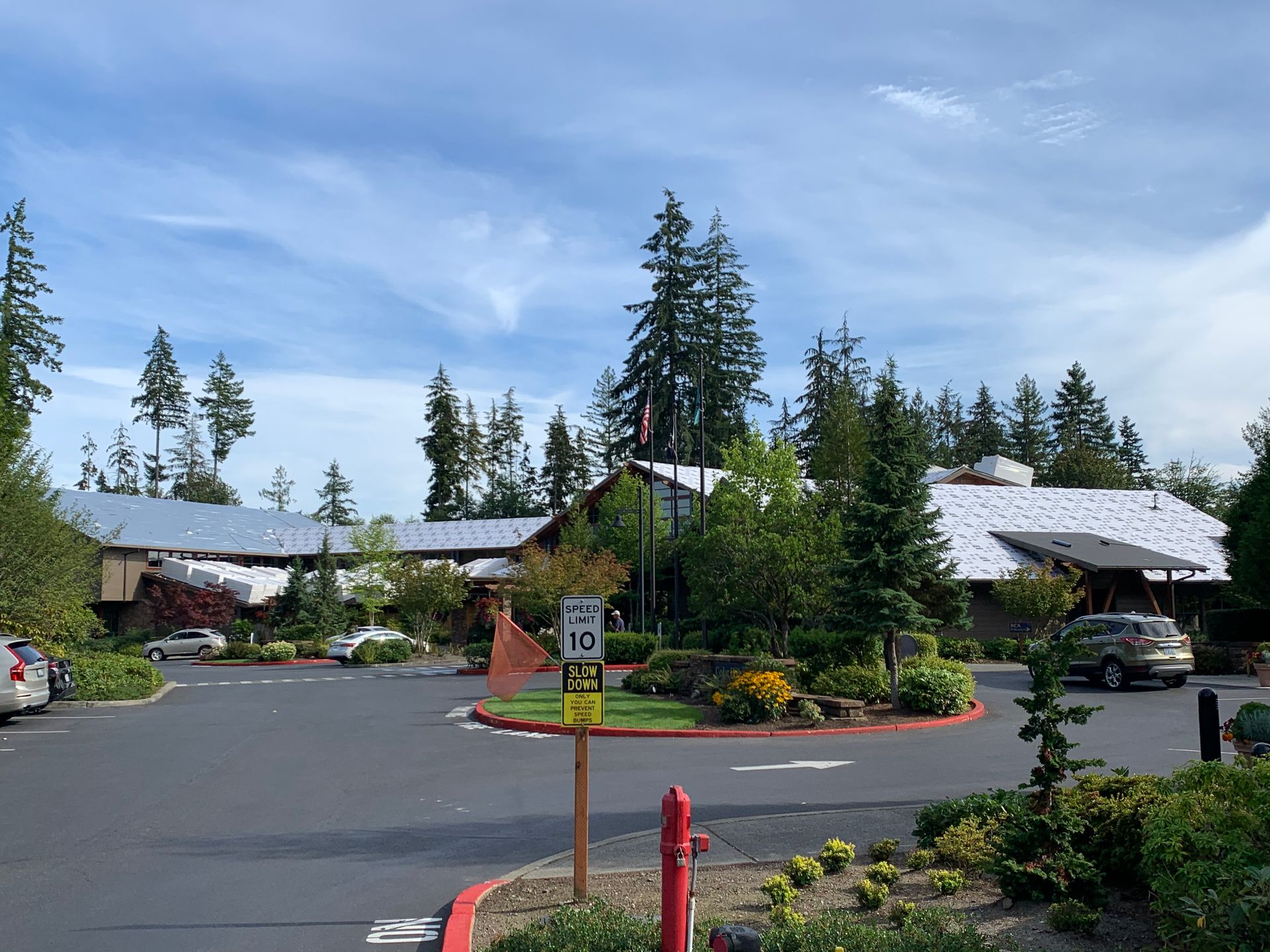 A parking lot with a fire hydrant in front of a building.