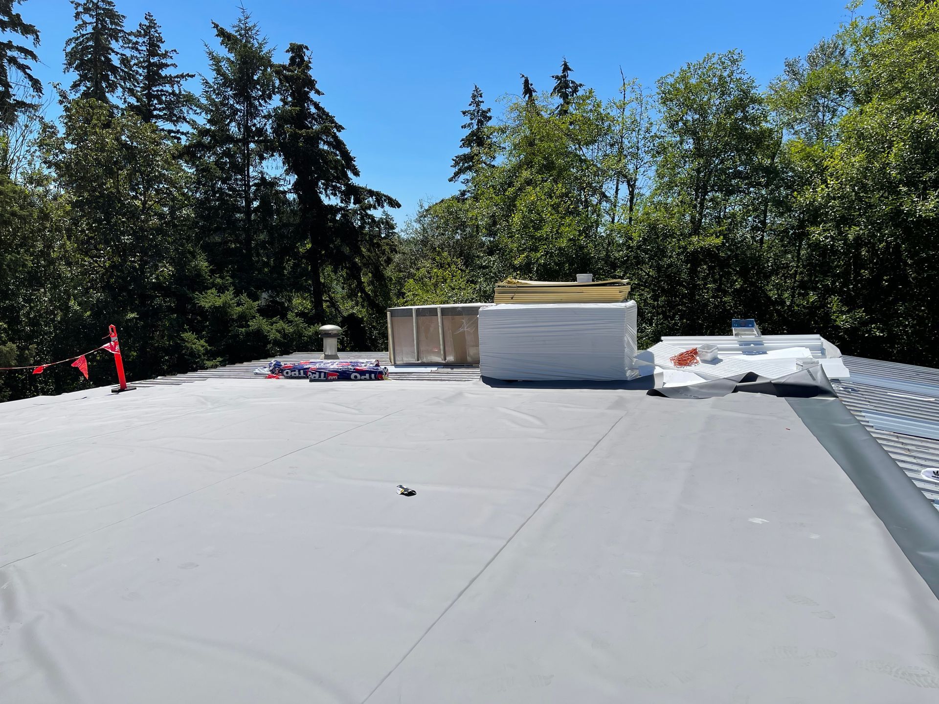 A roof with a few trees in the background