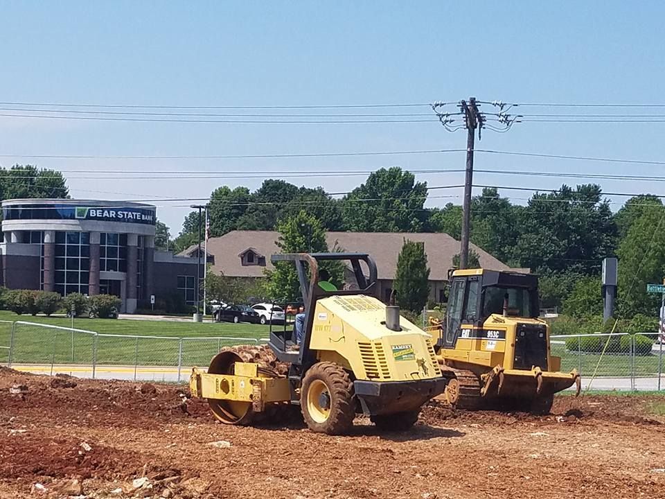A bulldozer and a vibratory roller on a construction site
