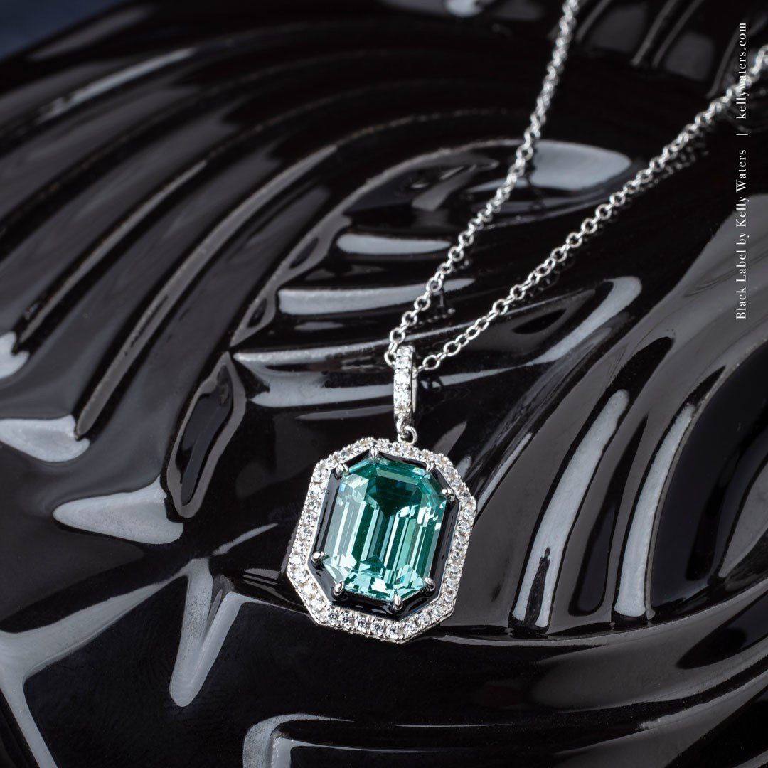 beautiful pendant with a green stone surrounded by diamonds