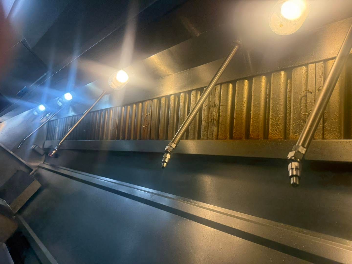A lit metal staircase or walkway at night with railings and overhead lights