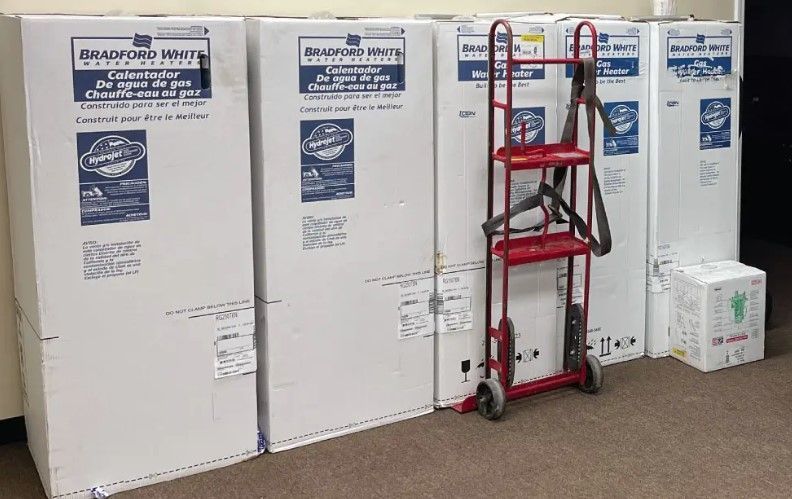 A red cart is sitting in front of a row of boxes