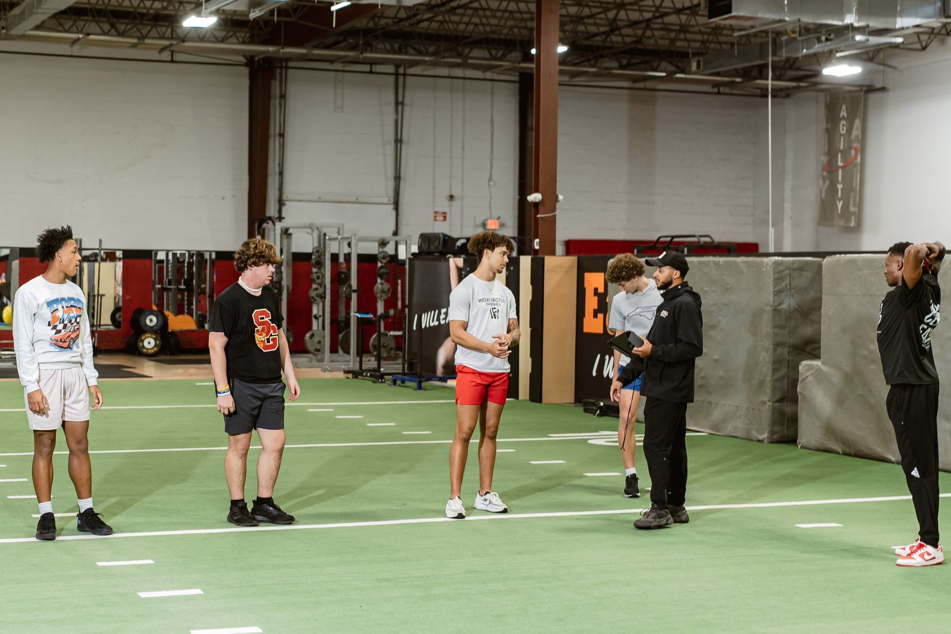 People standing in a gym during a group exercise or training session