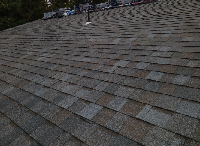 Dark grey asphalt shingle roof.