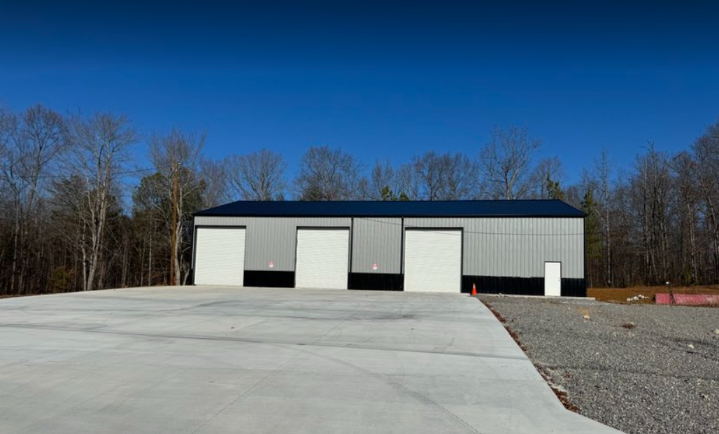 A large building with a concrete driveway in front of it.