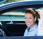 Happy Woman Showing The Key Of Car
