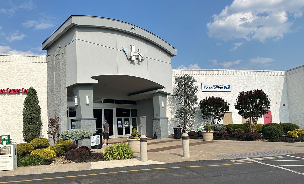 A large white building with a clock on the top of it.