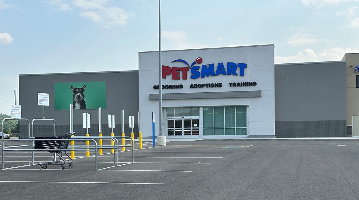 A petsmart store with a parking lot in front of it.