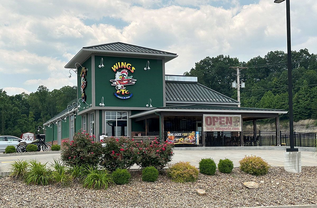 A green building with a sign that says