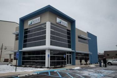 A large building with a handicapped parking spot in front of it