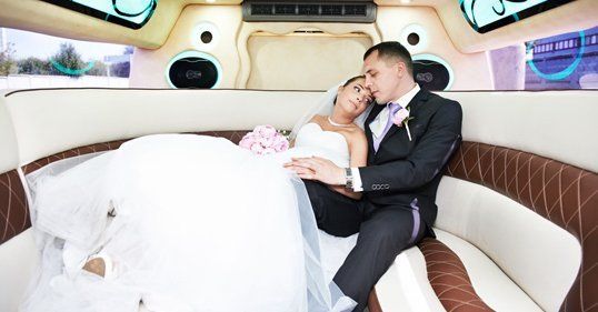 Bride and Groom relaxing in limousine