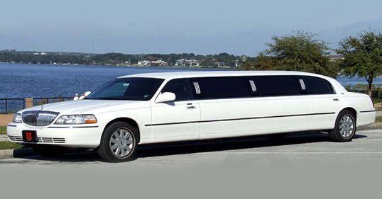 White limousine parked near water