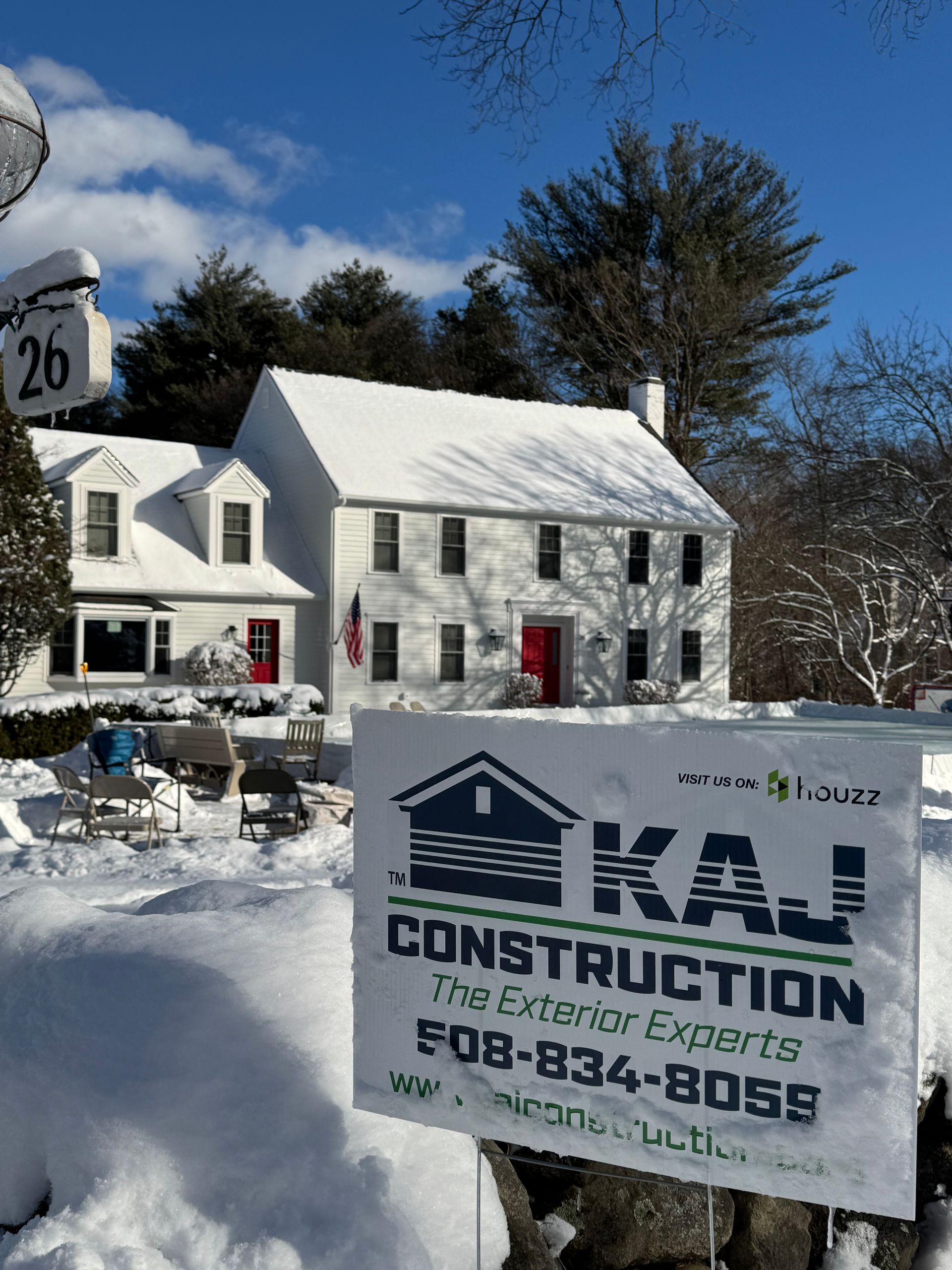 A white house with a construction sign in front of it
