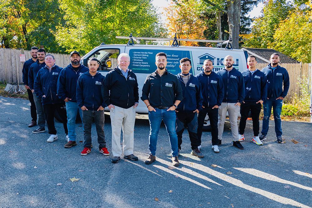 A group of men are posing for a picture in front of a van