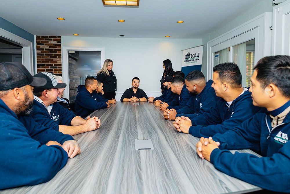 A group of men are sitting around a long table in a conference room