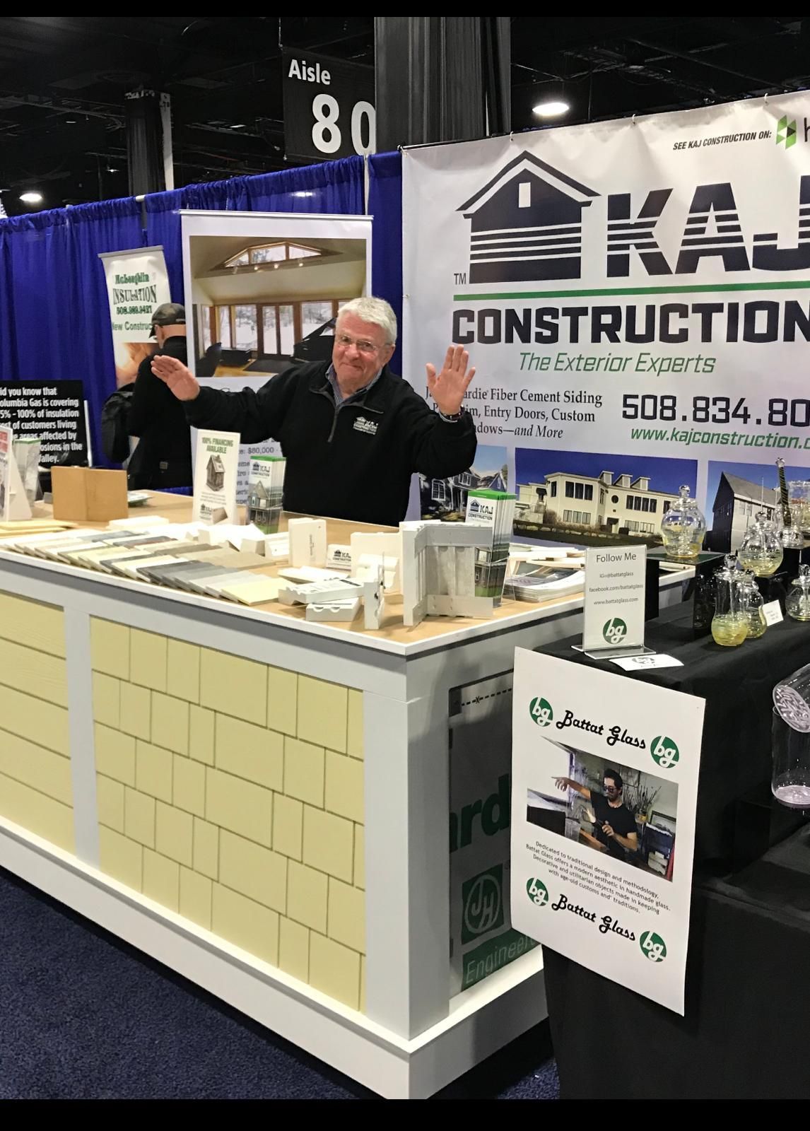 A man is standing in front of a construction booth.