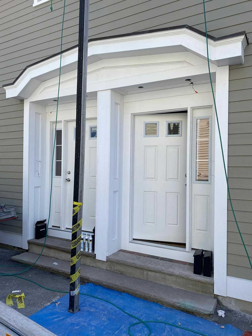 The front door of a house is being painted white