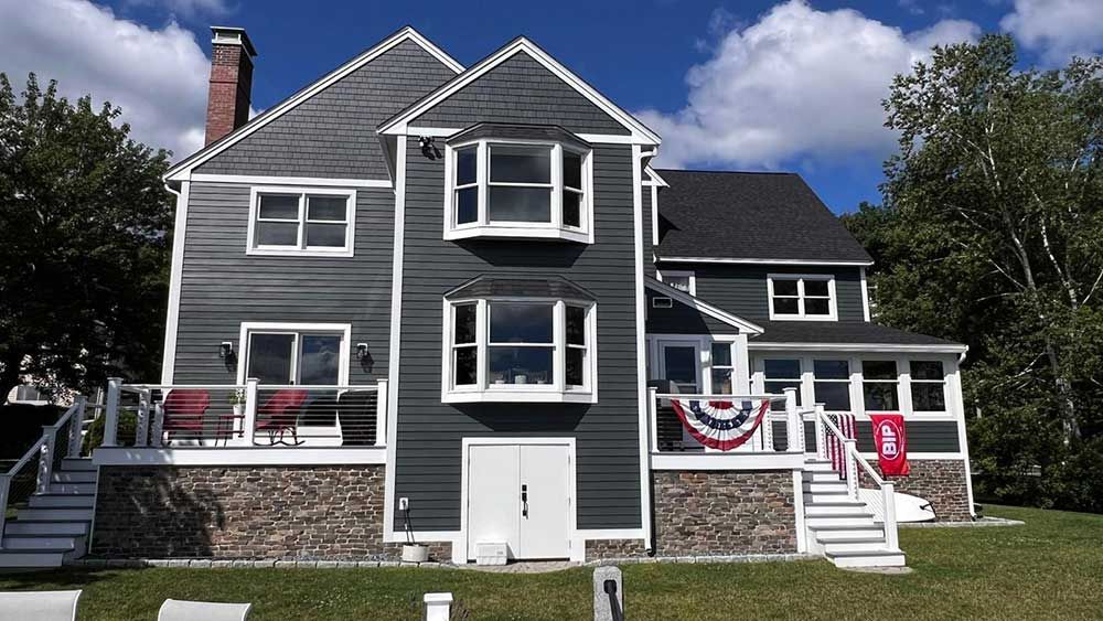 A large house with a flag on the front porch.