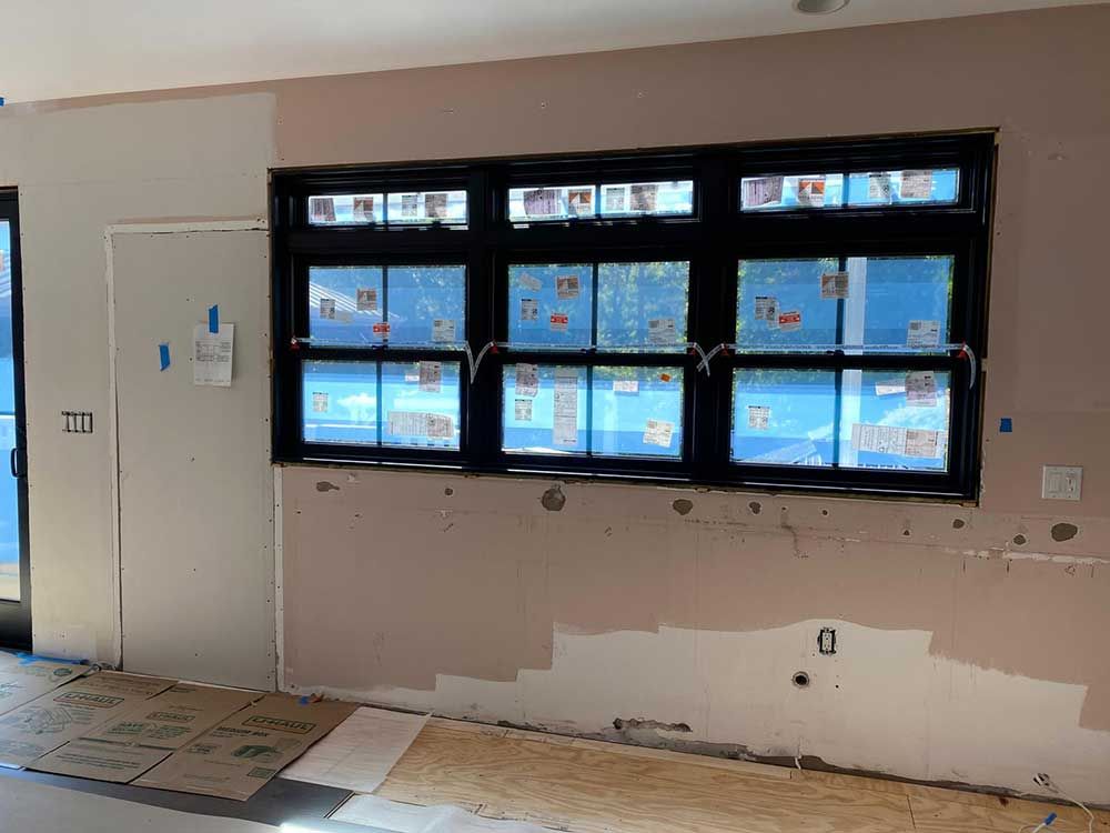 A room with a lot of windows and a door.