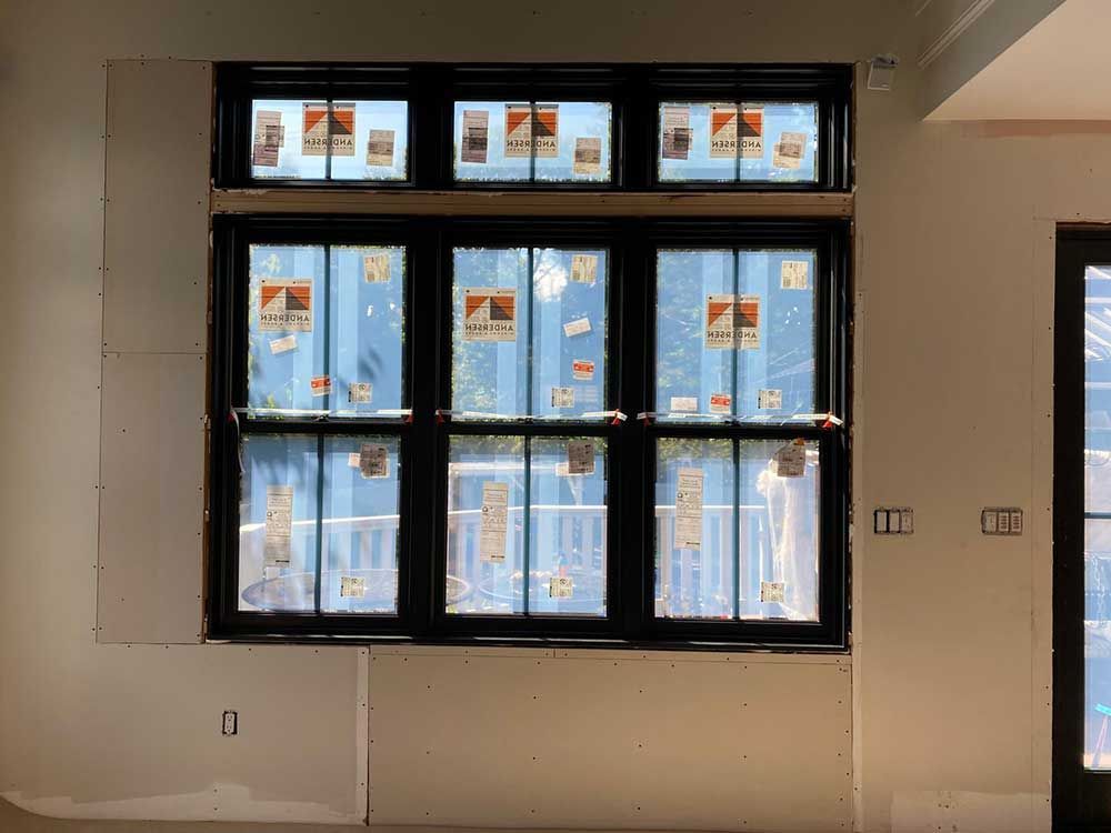 A room with a lot of windows and a door.