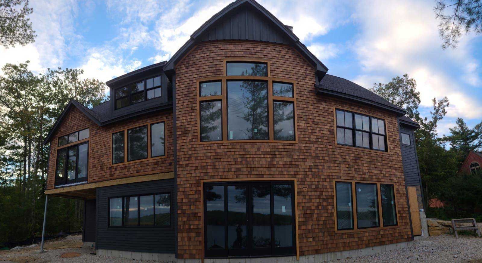 A large brick house with a lot of windows is being built.