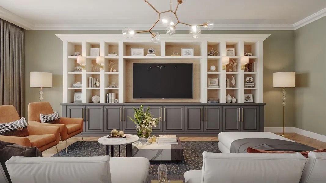 Living room with built-in shelving around a TV, two brown armchairs, white sofa, and a modern chandelier.