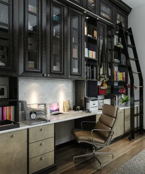 Home office with dark wood cabinets, white desk, leather chair, and rolling ladder.
