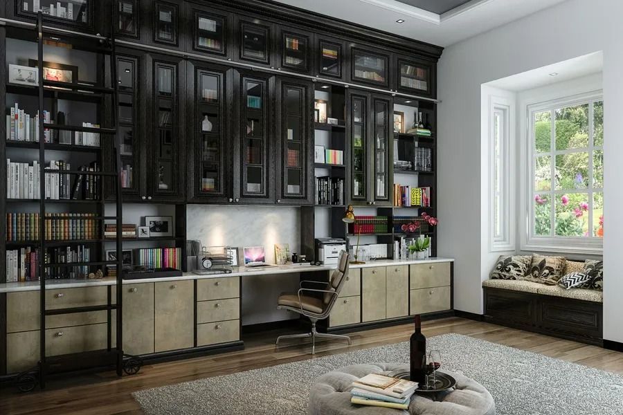 Home office with dark bookshelves, desk, and window seat.