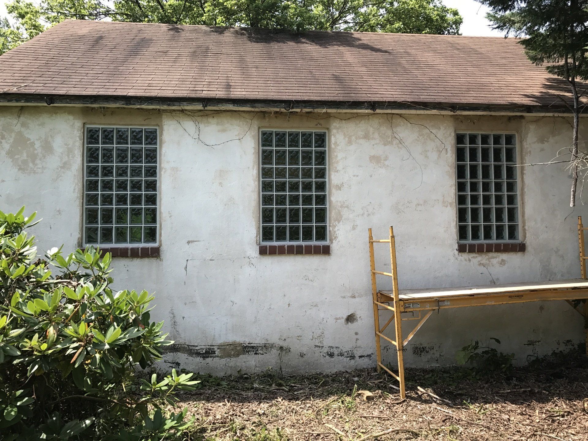 An old house with a newly replaced glass block window