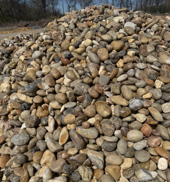 A pile of rocks with trees in the background