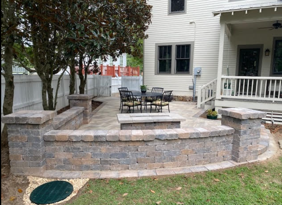 A large white house with a concrete driveway in front of it.