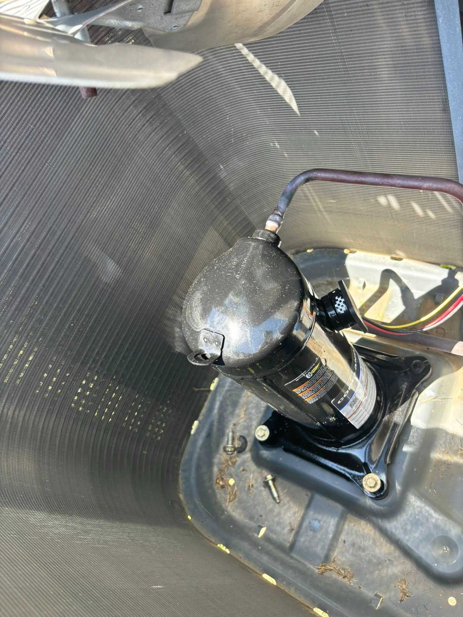 Black motor and bracket mounted on a gray mesh trampoline surface.