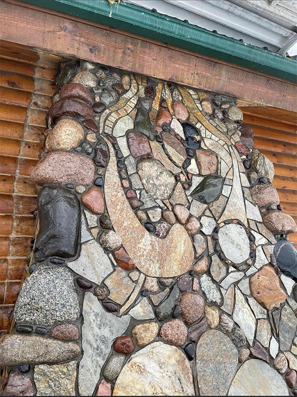 A stone wall with a stained glass design on it.