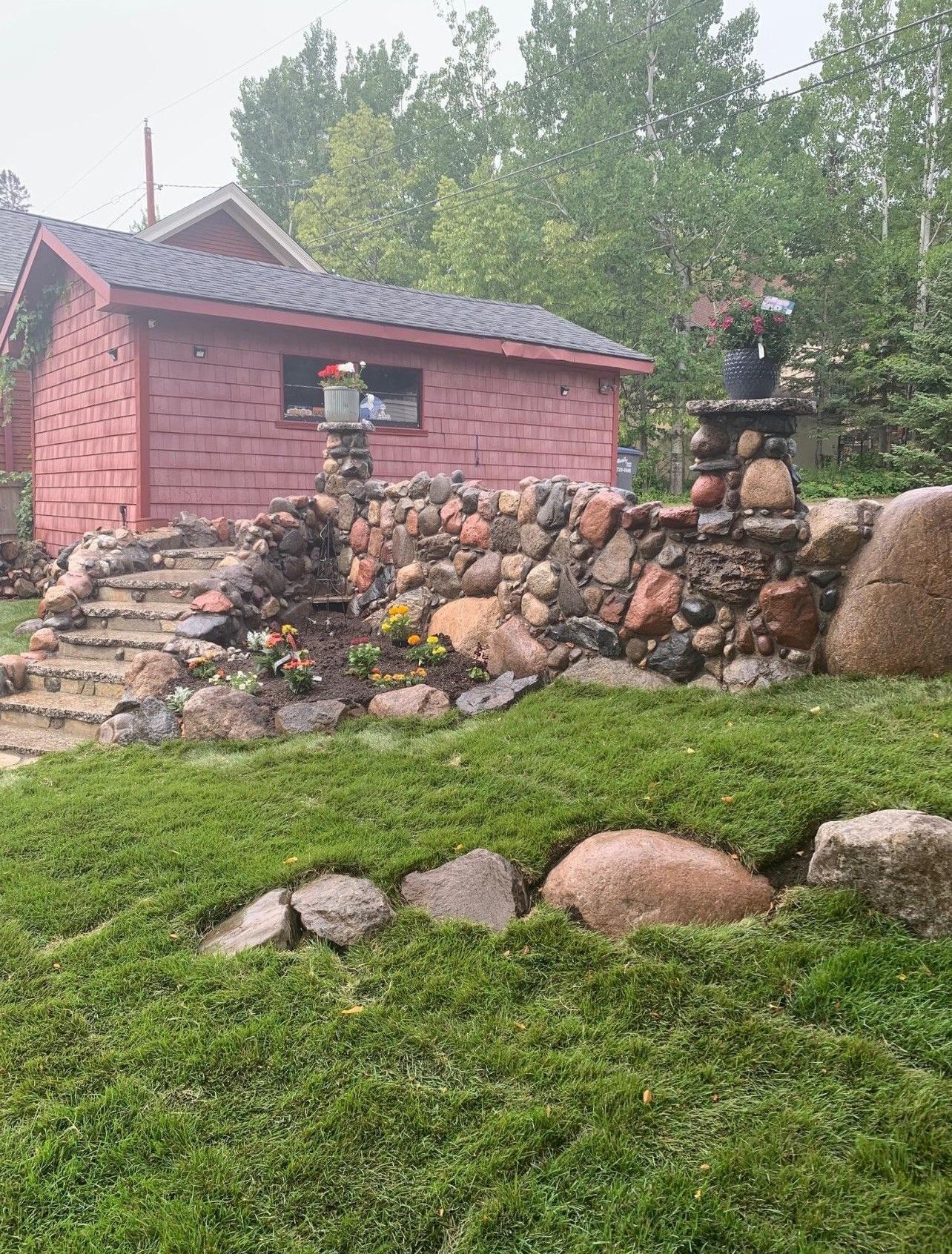 A house with a stone retaining wall and stairs