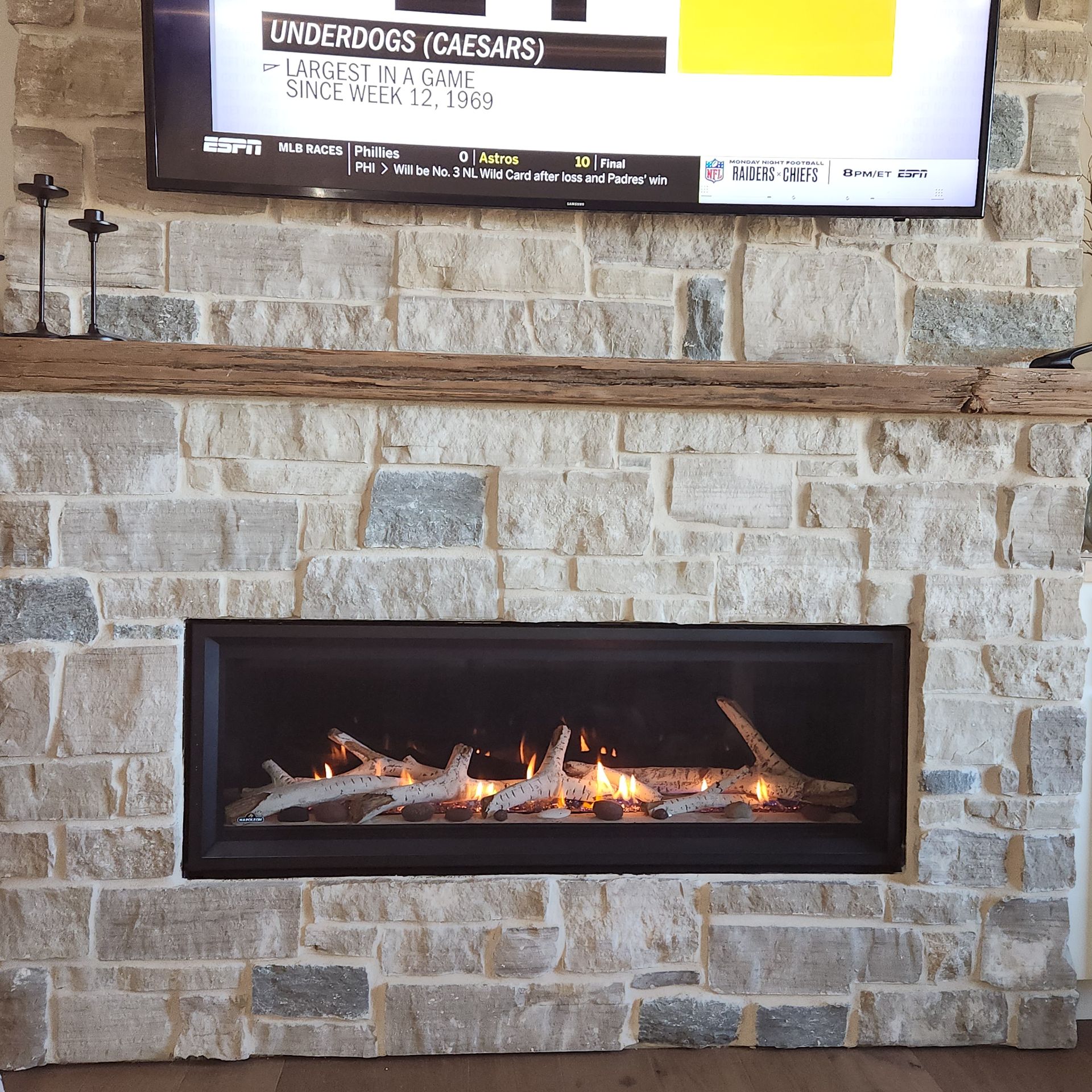 A fireplace with a tv above it.