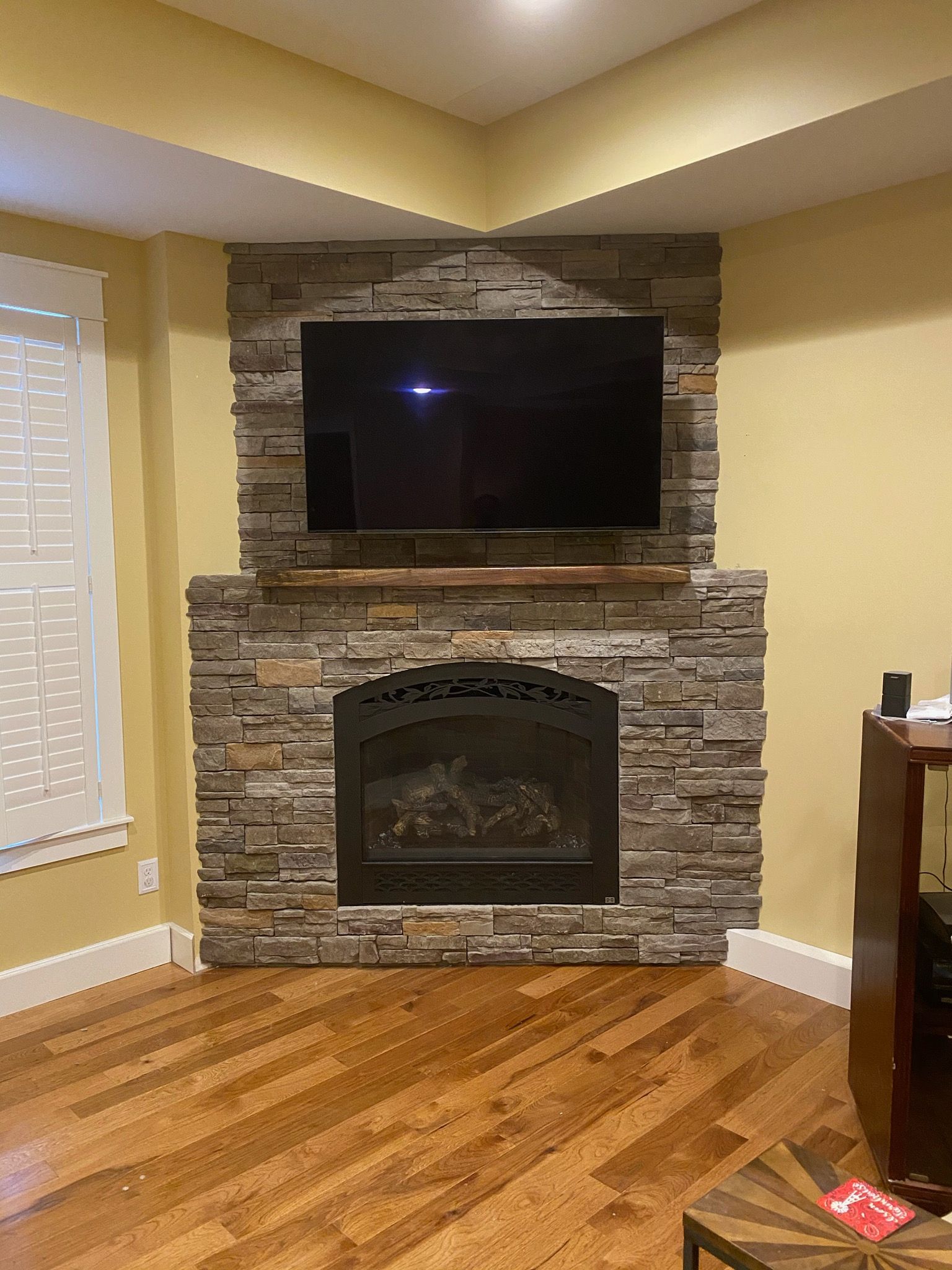 A living room with a fireplace and a flat screen tv.