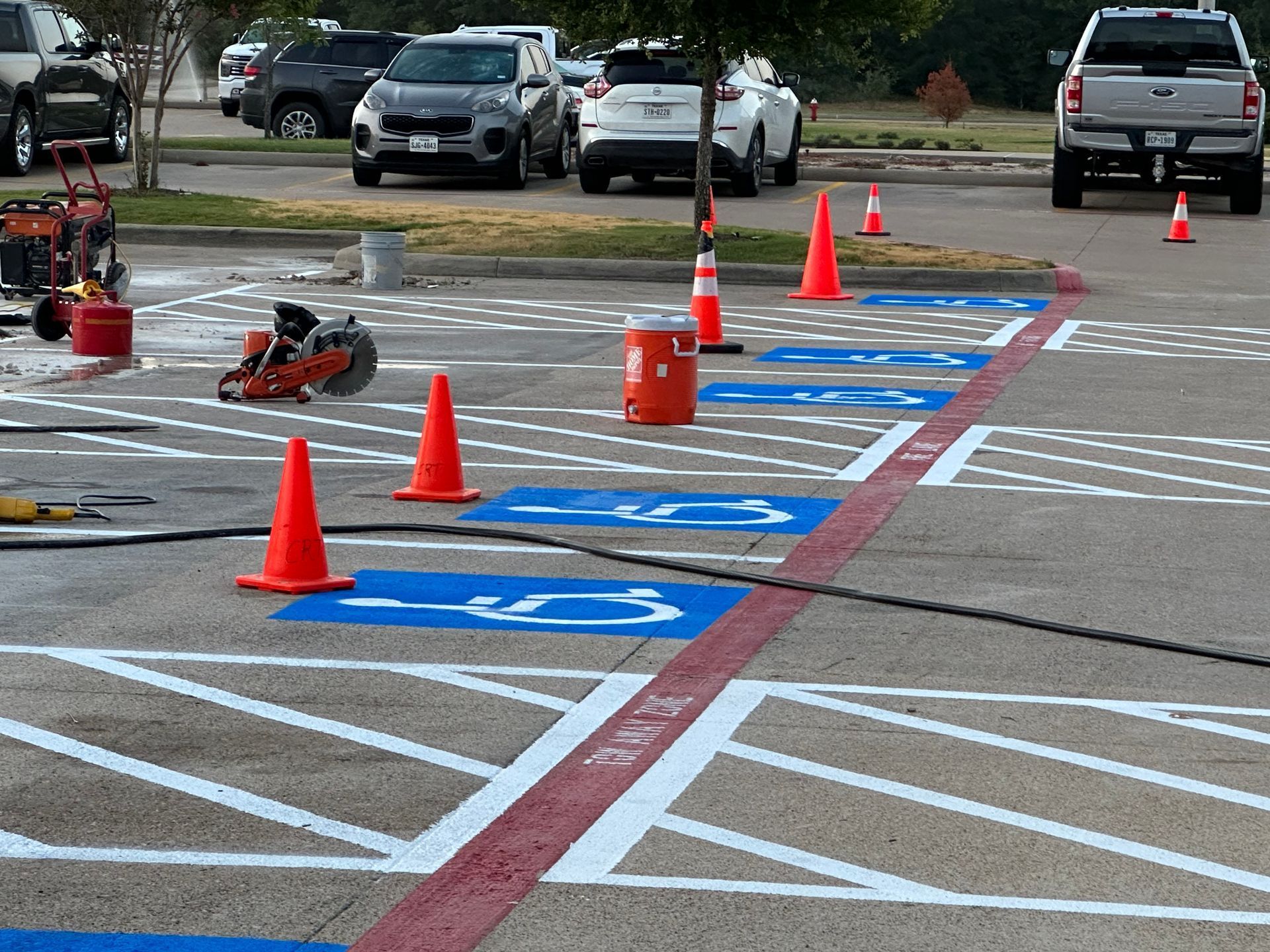 A parking lot with a handicapped parking spot and cones