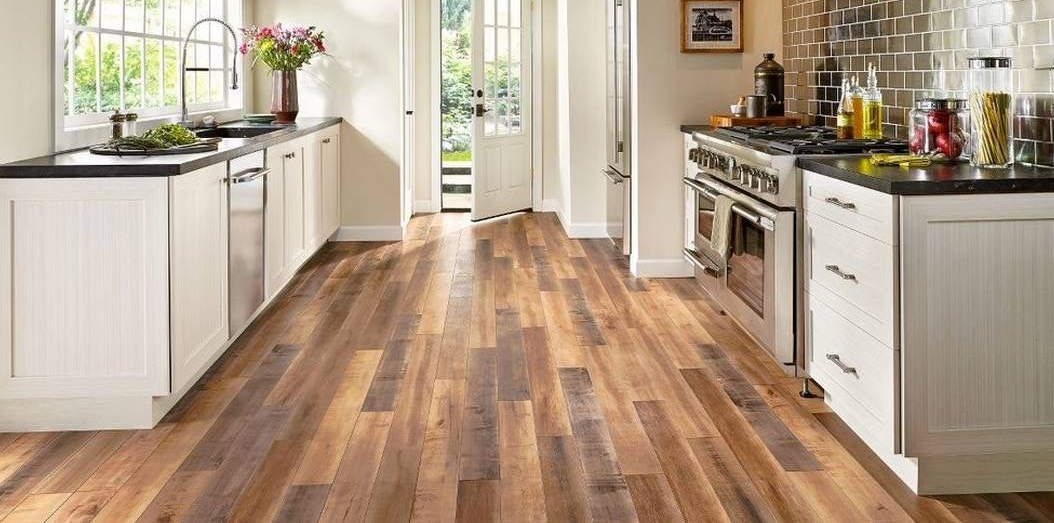 Kitchen with hardwood floors, white cabinets, and a stainless steel stove.